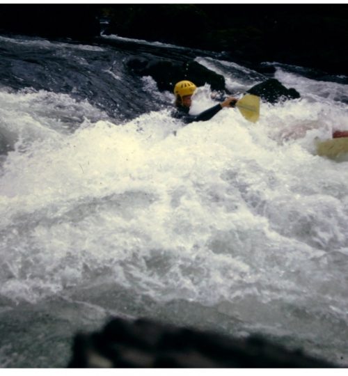 Fiberglass Kayak punching  Spencer's Hole, N. Santiam River. OKCC trip, November, 1972. The kayakers is the 16 yr old son of the author.